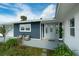 Renovated home entrance with light gray door and outdoor seating area at 1203 Marlowe Ave, Orlando, FL 32809