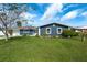 Newly renovated home with a blue exterior, white trim, and a lush green lawn at 1203 Marlowe Ave, Orlando, FL 32809