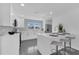 Modern kitchen boasts white cabinets, quartz countertops, and island seating at 1203 Marlowe Ave, Orlando, FL 32809