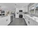 Modern kitchen with white cabinets, stainless steel appliances, and open layout at 1203 Marlowe Ave, Orlando, FL 32809