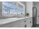 Kitchen features white shaker cabinets, quartz countertops, and large window at 1203 Marlowe Ave, Orlando, FL 32809