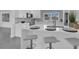Sleek kitchen with white cabinetry, quartz countertops, and breakfast bar at 1203 Marlowe Ave, Orlando, FL 32809