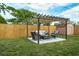 Relaxing patio area with a wooden pergola and comfortable seating at 1203 Marlowe Ave, Orlando, FL 32809