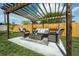 Backyard patio with a wooden pergola, wicker furniture, and a cozy atmosphere at 1203 Marlowe Ave, Orlando, FL 32809