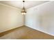 Simple dining room with neutral colored walls and carpeting at 1214 Romani Ave # 10240, Davenport, FL 33896
