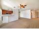 Bright living room with neutral carpeting and ceiling fan at 1214 Romani Ave # 10240, Davenport, FL 33896