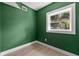 Cozy bedroom with green walls and wood-look flooring at 2072 Jessup Rd, Oviedo, FL 32765