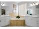 Luxurious bathroom featuring double vanities, soaking tub, and neutral tile at 219 Plumoso Loop, Davenport, FL 33897