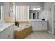 Main bathroom with corner soaking tub and double vanity at 219 Plumoso Loop, Davenport, FL 33897