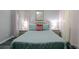 Bedroom with a queen bed, pale green bedding, and nightstands at 219 Plumoso Loop, Davenport, FL 33897