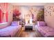 Two beds, a large mural, and a nightstand in this bedroom at 219 Plumoso Loop, Davenport, FL 33897
