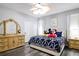 Comfortable bedroom with queen bed, dresser, and soft neutral color palette at 219 Plumoso Loop, Davenport, FL 33897