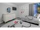 Charming bedroom with Mickey Mouse decor, two twin beds, and neutral walls at 219 Plumoso Loop, Davenport, FL 33897