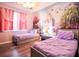 Charming bedroom with two twin beds, a mural, and plenty of light at 219 Plumoso Loop, Davenport, FL 33897