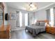Bedroom with a queen-size bed and large windows at 219 Plumoso Loop, Davenport, FL 33897