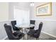 Cozy breakfast nook with glass table and stylish upholstered chairs at 219 Plumoso Loop, Davenport, FL 33897