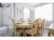 Bright dining room boasts a modern chandelier, six chairs, and natural light at 219 Plumoso Loop, Davenport, FL 33897