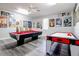 Spacious game room features a pool table, air hockey, and a collection of framed posters at 219 Plumoso Loop, Davenport, FL 33897