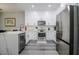 Modern kitchen with stainless steel appliances and white cabinets at 219 Plumoso Loop, Davenport, FL 33897