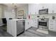 Bright kitchen features white cabinets, stainless steel appliances, and a stylish countertop at 219 Plumoso Loop, Davenport, FL 33897
