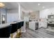 Modern kitchen featuring white cabinets, stainless steel appliances, and a large island with bar seating at 219 Plumoso Loop, Davenport, FL 33897