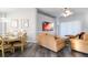 Inviting living room with a dining area, neutral tones, plush sofas, and hardwood floors at 219 Plumoso Loop, Davenport, FL 33897