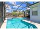 Large inviting pool with a spa and screened enclosure at 219 Plumoso Loop, Davenport, FL 33897