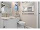 Updated bathroom offers a modern vanity with marble countertop and decorative mirrors at 228 Westwood Dr, Leesburg, FL 34748