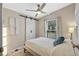 Bedroom with a bed, barn door, and ceiling fan at 228 Westwood Dr, Leesburg, FL 34748