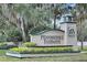 A welcoming Pennbrooke Fairways community sign surrounded by lush landscaping and mature trees at 228 Westwood Dr, Leesburg, FL 34748