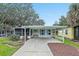 Single-story home with carport and landscaped yard at 228 Westwood Dr, Leesburg, FL 34748