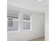 Bright bedroom with two windows and gray carpeting at 248 Links Terrace Blvd, Daytona Beach, FL 32124