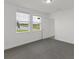 Bedroom with gray carpet, two windows overlooking a lake, and a door at 248 Links Terrace Blvd, Daytona Beach, FL 32124