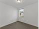Small bedroom with gray carpet and one window at 248 Links Terrace Blvd, Daytona Beach, FL 32124