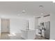 Open concept kitchen with island, stainless steel appliances, and white cabinets at 248 Links Terrace Blvd, Daytona Beach, FL 32124