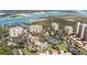 Aerial view of community with pool, tennis courts, and waterfront access at 263 Minorca Beach Way # 301, New Smyrna Beach, FL 32169