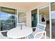 Relaxing balcony with table and chairs overlooking landscape at 263 Minorca Beach Way # 301, New Smyrna Beach, FL 32169