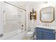Clean bathroom with a blue vanity, shower, and bathtub at 263 Minorca Beach Way # 301, New Smyrna Beach, FL 32169