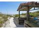 Beach access with a wooden shelter at 263 Minorca Beach Way # 301, New Smyrna Beach, FL 32169
