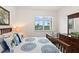 Bedroom with a queen bed, dresser, and ocean view at 263 Minorca Beach Way # 301, New Smyrna Beach, FL 32169