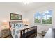 Bright bedroom with a queen bed, window, and wood dresser at 263 Minorca Beach Way # 301, New Smyrna Beach, FL 32169