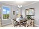 Bright dining area with a square table and four chairs and water views at 263 Minorca Beach Way # 301, New Smyrna Beach, FL 32169