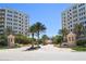 Attractive community entrance with palm trees and building view at 263 Minorca Beach Way # 301, New Smyrna Beach, FL 32169