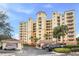 Elegant multi-story building with palm trees and gated entrance at 263 Minorca Beach Way # 301, New Smyrna Beach, FL 32169
