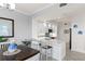 Modern kitchen with white cabinets, quartz countertops, and tile backsplash at 263 Minorca Beach Way # 301, New Smyrna Beach, FL 32169