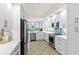 Modern kitchen with white cabinets, quartz countertops and stainless steel appliances at 263 Minorca Beach Way # 301, New Smyrna Beach, FL 32169