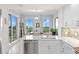 Modern kitchen with island, white cabinets and stainless steel appliances at 263 Minorca Beach Way # 301, New Smyrna Beach, FL 32169