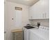 Laundry room with washer, dryer, and cabinets at 263 Minorca Beach Way # 301, New Smyrna Beach, FL 32169