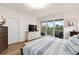 Main bedroom with king bed, balcony access, and water views at 263 Minorca Beach Way # 301, New Smyrna Beach, FL 32169