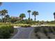 Brick pathway meanders through lush landscaping at 263 Minorca Beach Way # 301, New Smyrna Beach, FL 32169